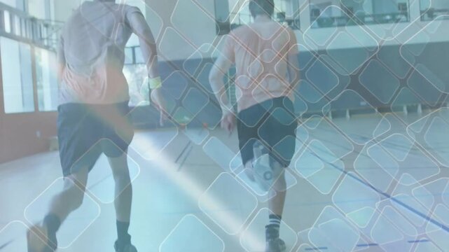 Athletes starting sprint under scoreboard in gym as third athlete joining for sports training