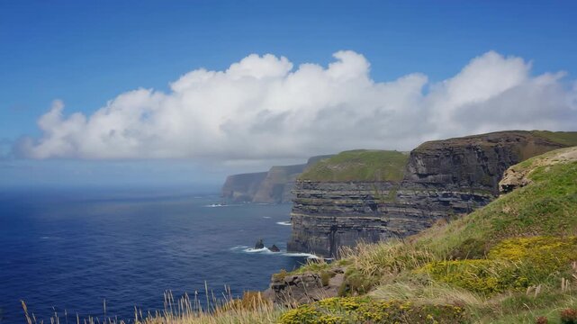 Fixed camera angle of clouds rolling across coastal cliffs
