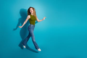 Excited young woman in casual outfit, showcasing dynamic energy and trendy style against a bright...