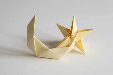 Charming origami art showcasing a moon and star sculpture crafted from paper on a neutral background, ideal for celestial themes.