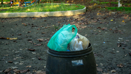 Overflowing Trash Bin in Public Park Highlighting Waste Management Issues