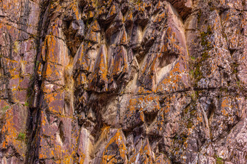 Rugged rock formation on rocky cliff face in nature