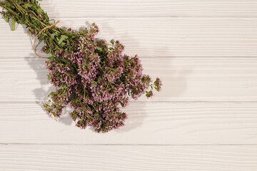 Bouquet of oregano on a wooden table for collecting useful herbs and treatment according to folk...