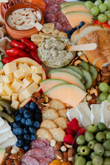 Delicious charcuterie spread featuring meats, cheeses, fruits, and nuts for a festive gathering on...