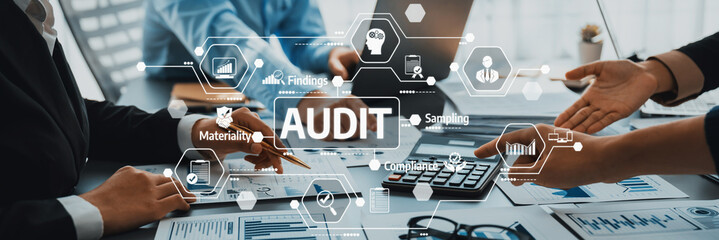 A modern office scene showcasing the audit process. Business professionals engage with technology...