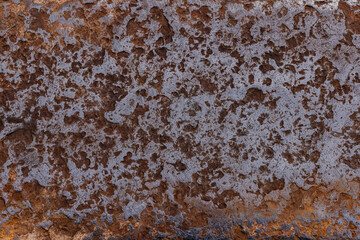 Textured rusted surface on outdoor wall during daytime