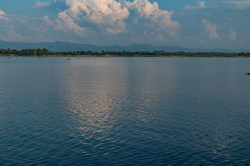 Hill reflections on crystal clear lake surface.