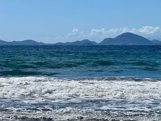 Seascape of Guadeloupe with a view of the Caribbean Sea and the island of Les Saintes in the background
