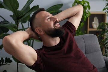 Fototapeta premium Harmony. Man relaxing in comfortable armchair at home