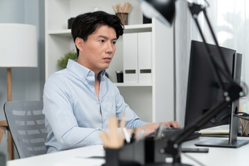 Serious smart businessman working on computer to check email with business project report,...
