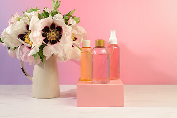 Spa salon advertising card, Wellness composition with rose water, fresh flowers of mountain peony and columbine, concept of natural self-care and healthy lifestyle, abstract composition with flowers.