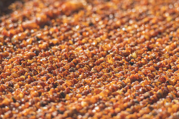 Many small pieces of raw amber of different colours in a street local traditional market
