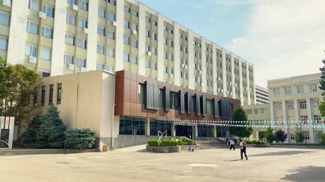 Tbilisi, Georgia - 16th july, 2025: Group of indian students walking to Tbilisi state medical university building. Casual atmosphere, academic lifestyle, future doctors, urban campus