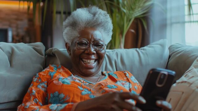 Woman aged 65 years old sits on couch, phone in hand