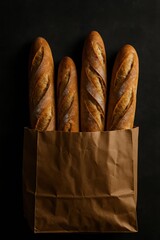 four baguettes in a paper bag on a black background
