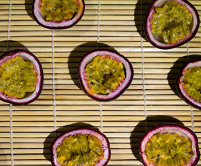 Fresh Passion Fruits Halved on a Bamboo Mat Background