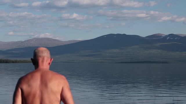 Klocka, Sweden A man bathes in the remote &Aring;nnsj&ouml;n Lake in the J&auml;mtland region.  