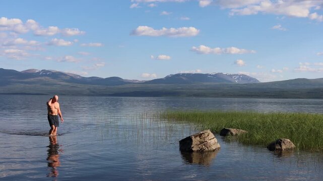 Klocka, Sweden A man bathes in the remote &Aring;nnsj&ouml;n Lake in the J&auml;mtland region.  