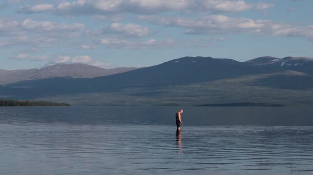 Klocka, Sweden A man bathes in the remote &Aring;nnsj&ouml;n Lake in the J&auml;mtland region.  