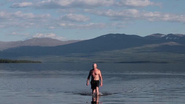 Klocka, Sweden A man bathes in the remote &Aring;nnsj&ouml;n Lake in the J&auml;mtland region.  