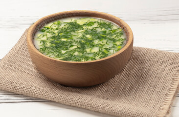 Okroshka - cold summer soup in a bowl close-up