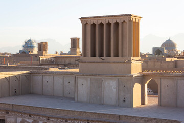 Historic windcatcher in Yazd, Iran, stands tall against a vivid blue sky—an iconic example of ancient Persian architecture and sustainable design.