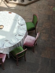 Elegant dining setup with colorful chairs in a spacious venue during daylight