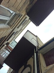 Views from a narrow alley showcasing balconies and old architecture in a quiet neighborhood