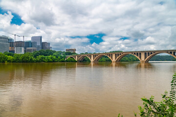 Business District View from Georgetown over Potomac River
Contemporary office buildings and city infrastructure framed by green trees and water.