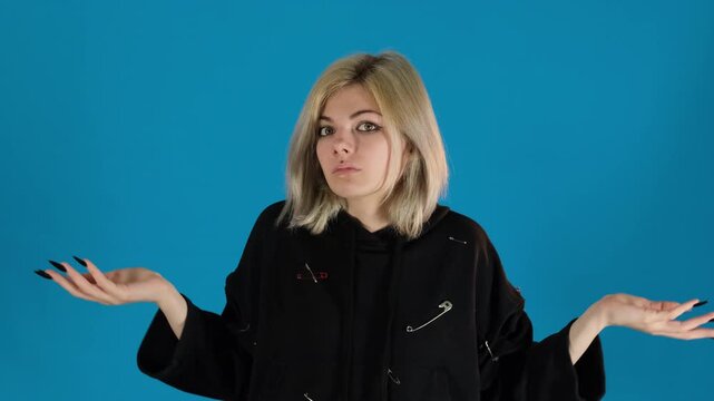 Young girl spreads hands wide with face twisted in frustration. Woman clearly puzzled trying to figure out things going wrong on blue