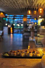 dynamite shrimp roll sushi on a black plate. Stylish Sushi plate