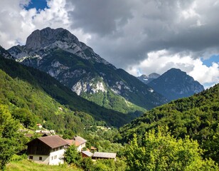 Fototapeta premium Alpine valley with village nestled in the foothills