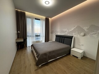 Modern Cozy Bedroom with Mountain Wall Mural and Large Window