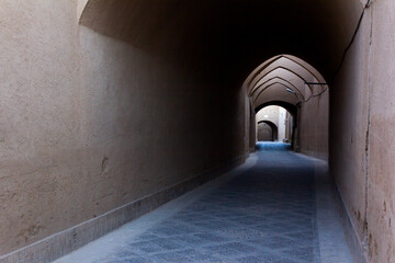 Traditional vaulted alleyway in Yazd, Iran, showcasing mud-brick architecture and the timeless charm of ancient Persian urban design.