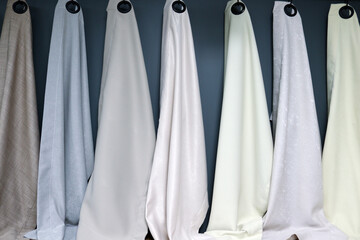 curtain samples hanging on a showroom rail