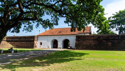 Ancient gateway, shaded by large tree
