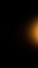Blurry orange light on black background