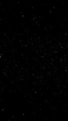 A vast black expanse speckled with tiny white dots