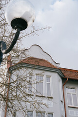 Historical architecture. modenrn. large building with a red roof and white trim. There are many windows in the building, including a large window on the facade.