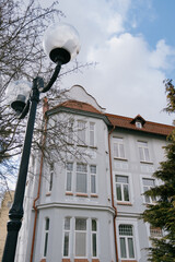 Historical architecture. modenrn. large building with a red roof and white trim. There are many windows in the building, including a large window on the facade.
