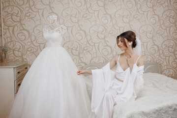Bridal preparation in a soft-lit room with elegant dress and serene atmosphere