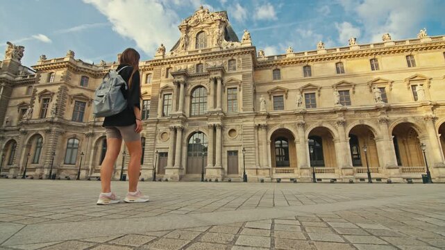 Woman walking near Louvre art museum in Paris France. Europe tourist exploration, beautiful architecture of squares with art gallery.