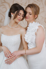 Bridal moments shared between mother and daughter in elegant attire