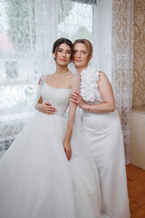 Bridal moment captured in a beautifully decorated room with elegant attire