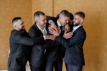 Friends celebrating together in formal attire during a joyful gathering indoors