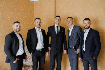 Group of well-dressed men smiling together in a stylish room before an event