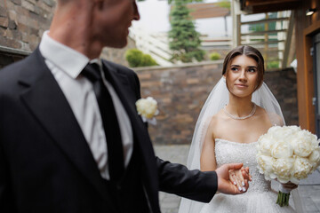 Couple shares a romantic moment during their wedding ceremony in a lovely outdoor setting