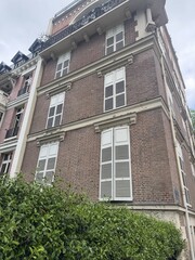 Facade of high building with brick walls and big windows