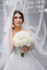 Bride in wedding dress with bouquet captures enchanting moment in elegant setting