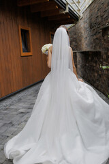 Outdoor wedding ceremony featuring a bride in a flowing white gown with a veil